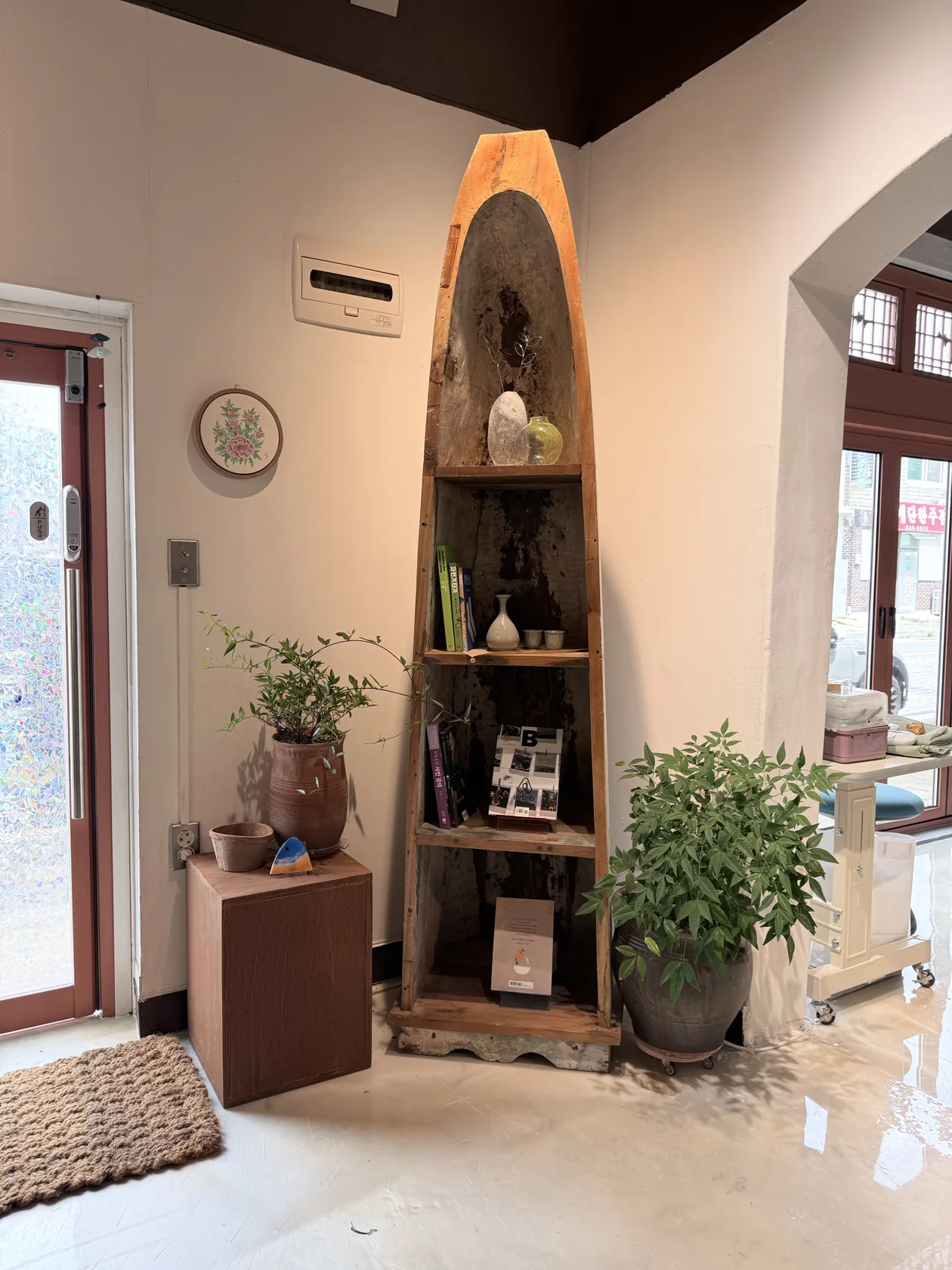 A boat-shaped shelf holding books and small objects