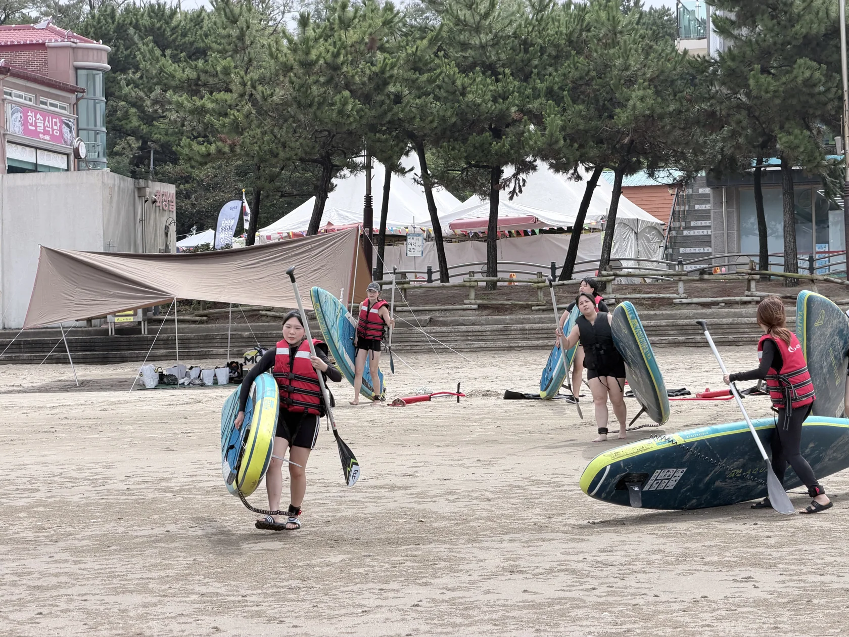 Carrying the boards towards the sea together