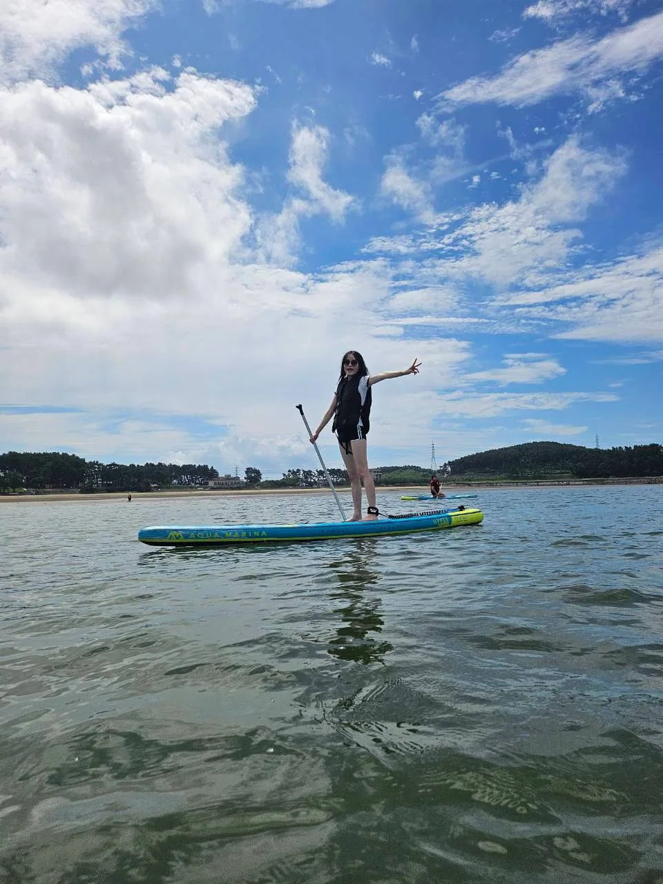 Standing on a board beneath a blue sky
